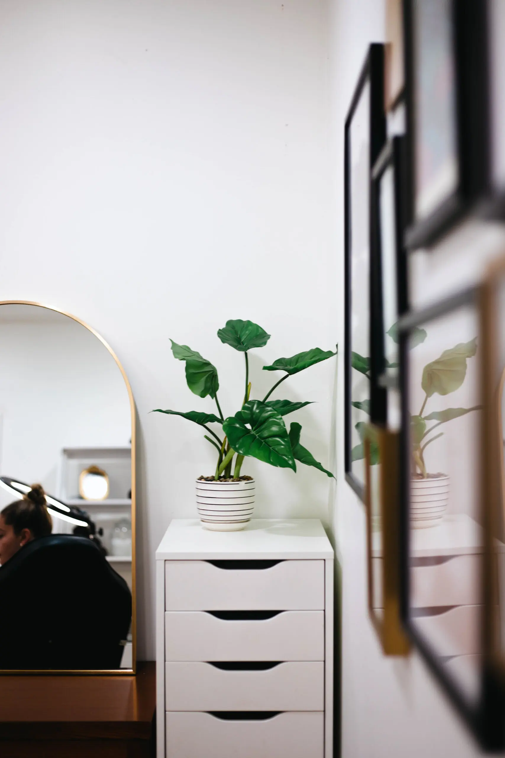Treatment suite with gold-framed mirror and vanity station